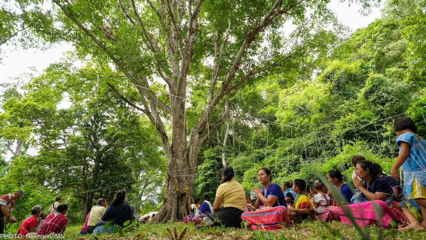 Huay Ee Khang villagers and neighbors from nearby villages in Chiang Mai, Thailand are participating in their traditional ritual to inform the guardian spirits before releasing fish into Mae Wan stream.