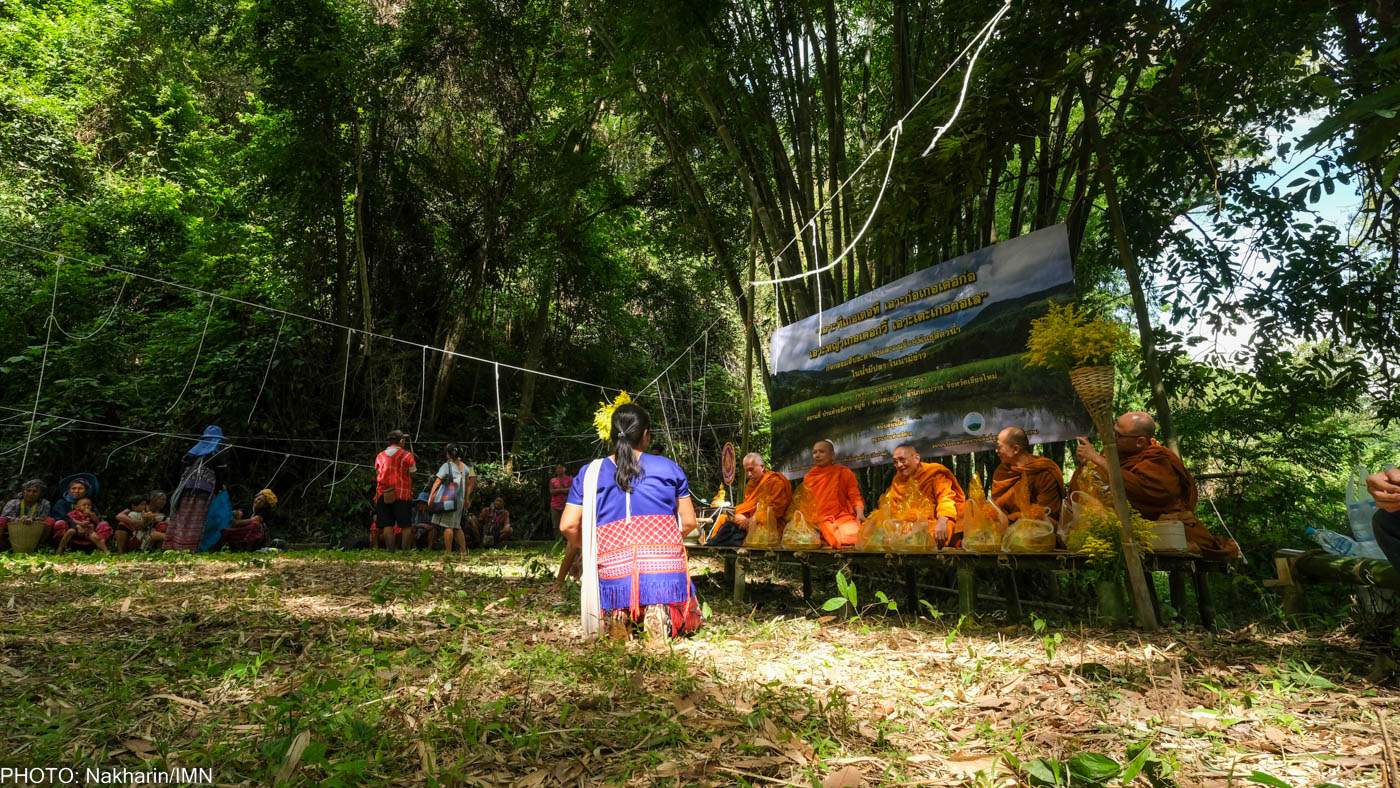 Huay Ee Khang villagers and neighbors from nearby villages in Chiang Mai, Thailand are participating in their traditional ritual to inform the guardian spirits before releasing fish into Mae Wan stream.