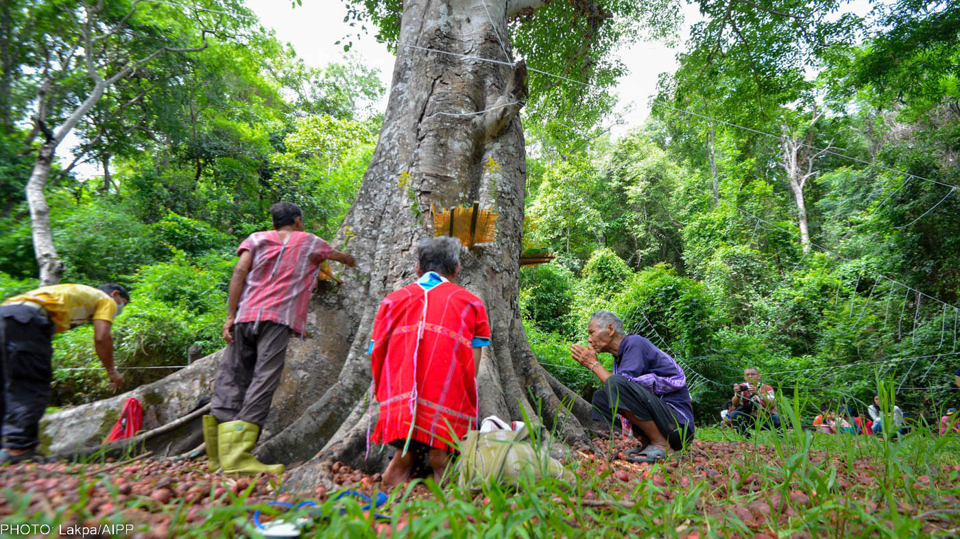 Huay Ee Khang villagers and neighbors from nearby villages in Chiang Mai, Thailand are participating in their traditional ritual to inform the guardian spirits before releasing fish into Mae Wan stream.