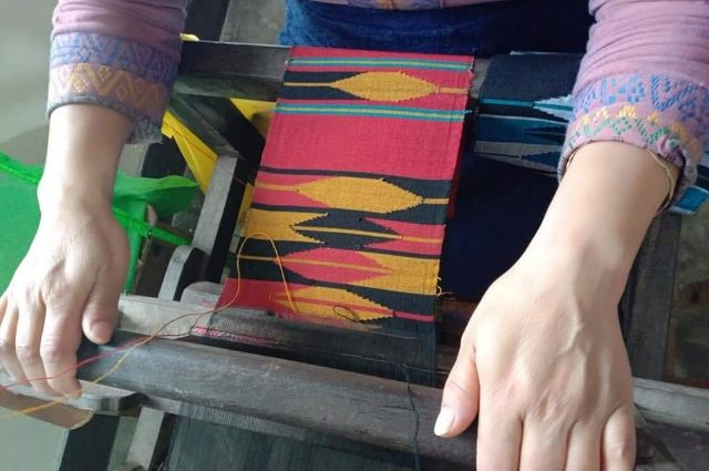 Wooden loom with warp and weft